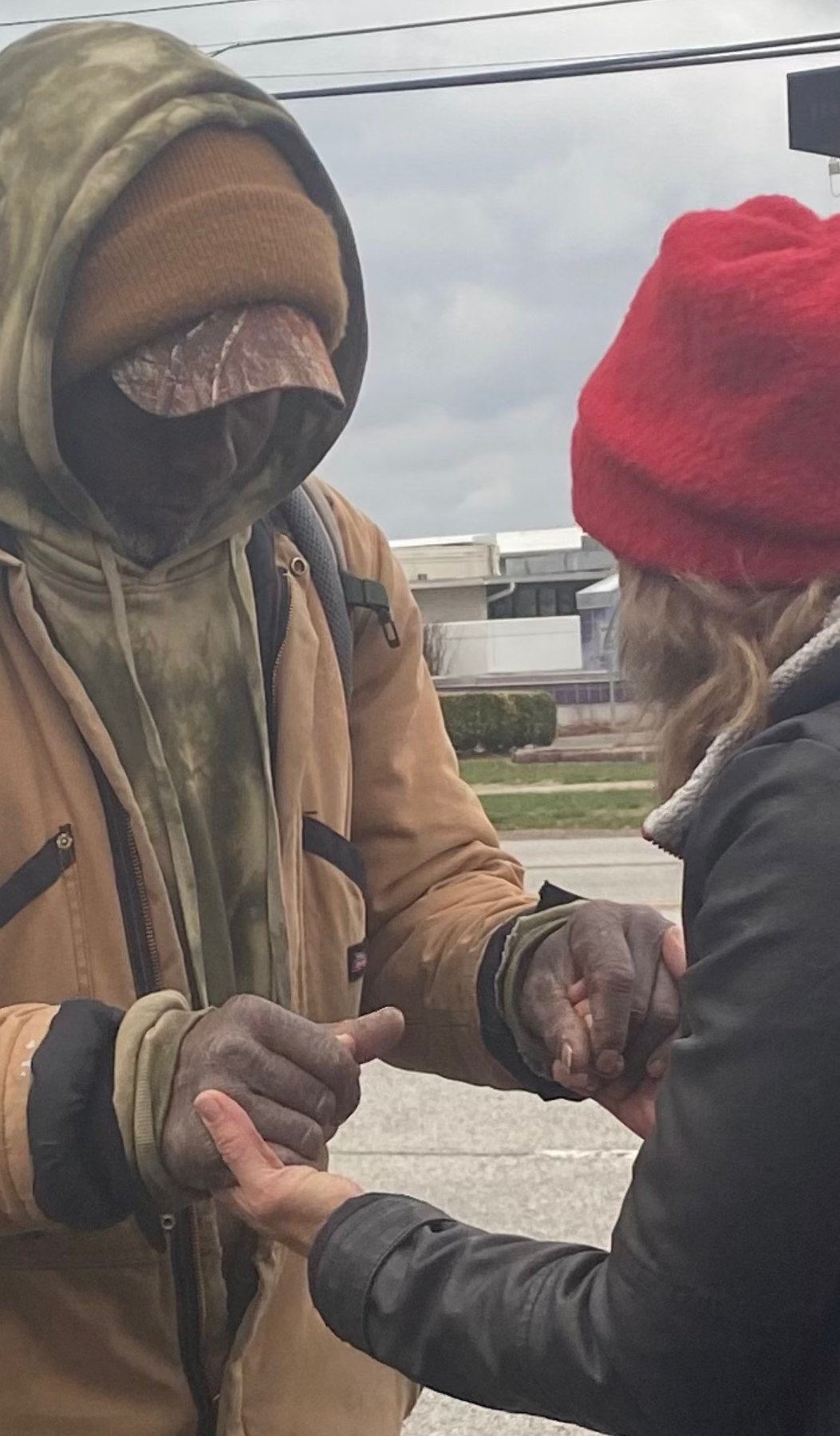 Holding hands in prayer on a street corner