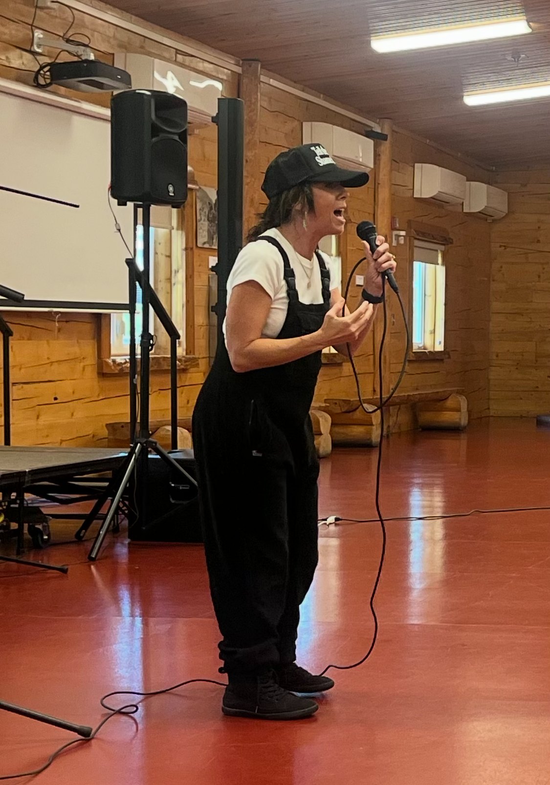 Speaking to a room at a camp meeting hall