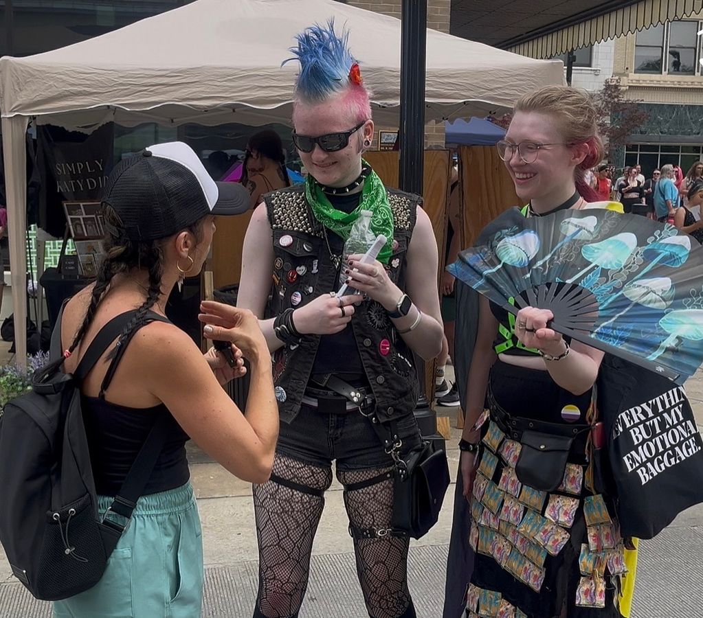 Talking with two people at a street festival