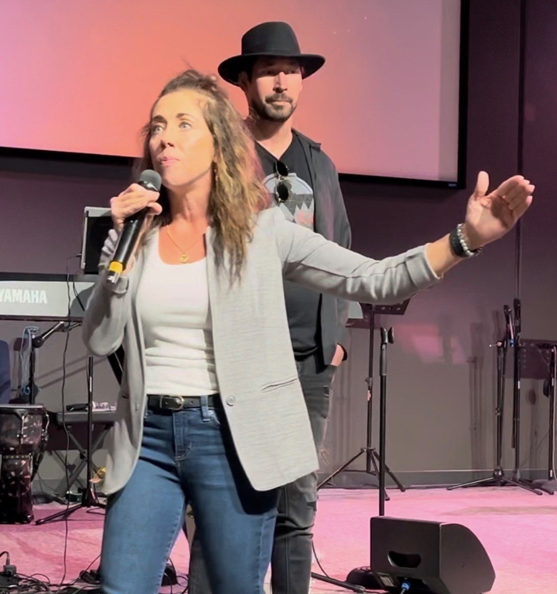 Jeremy and Sarah Dunston speaking from a church stage